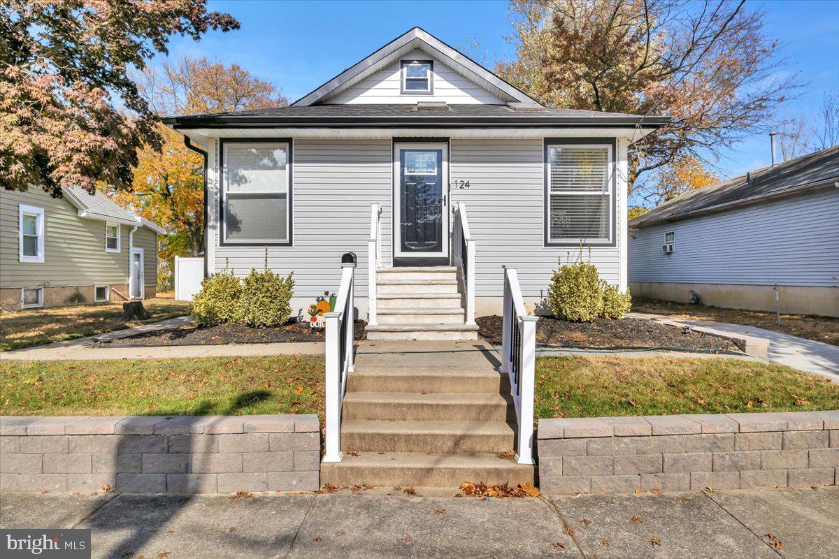 a front view of a house with a yard and seating space