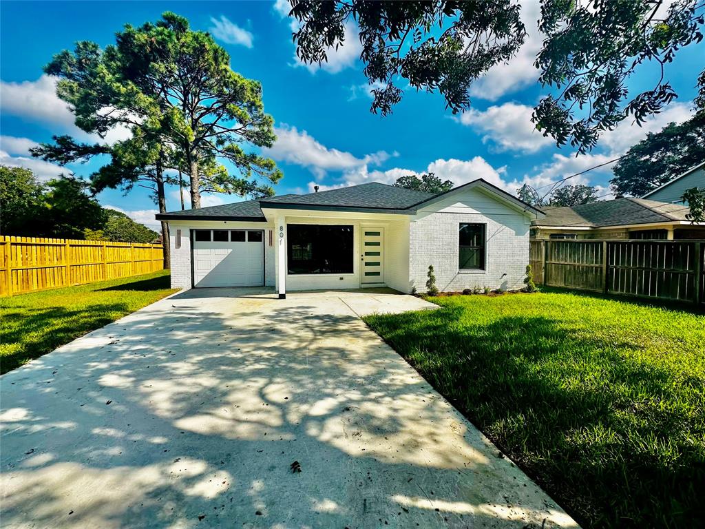 a view of a house with a backyard