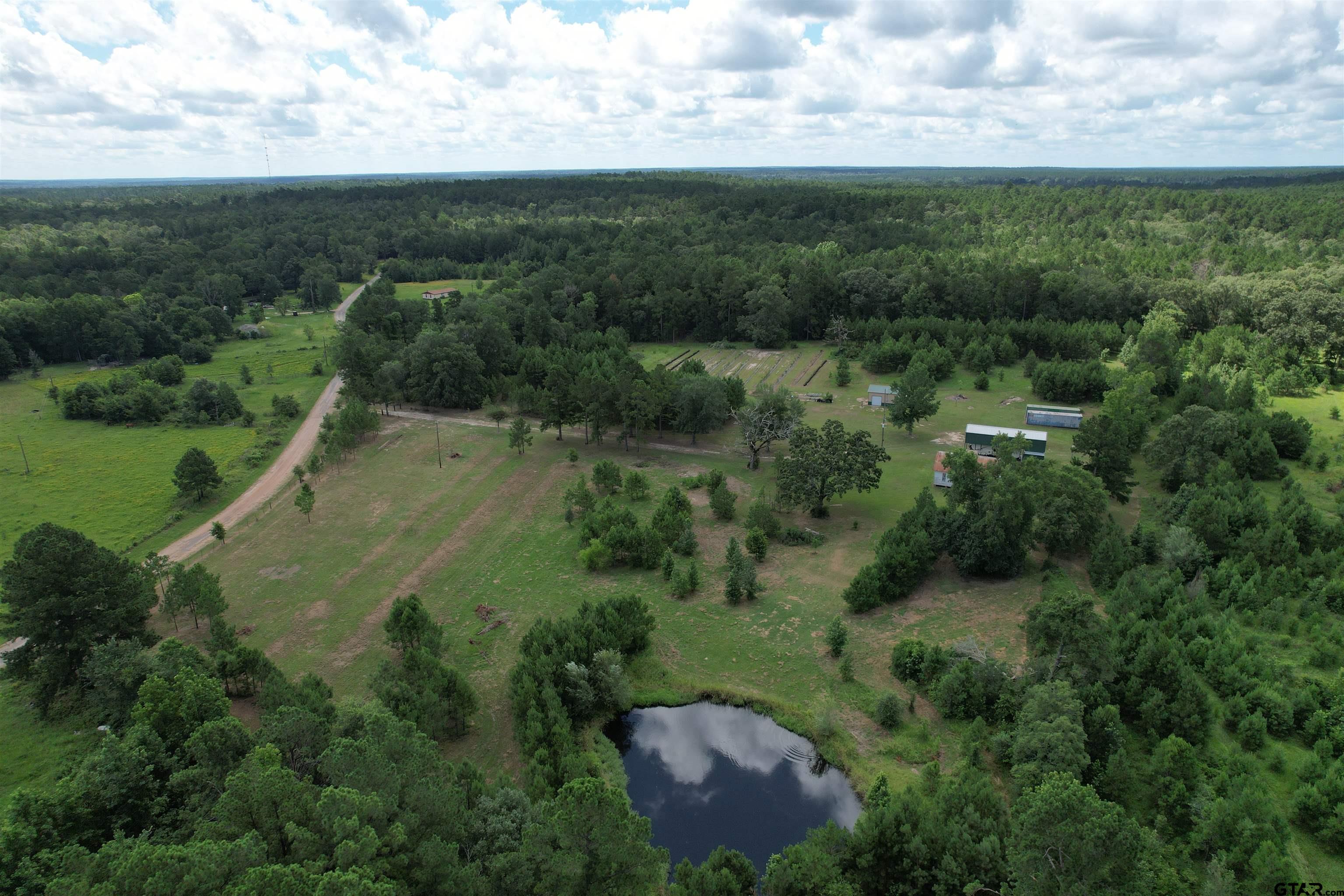 an aerial view of a houses with outdoor space and trees