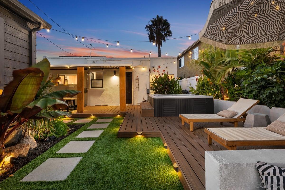 a view of a patio with table and chairs potted plants with wooden floor