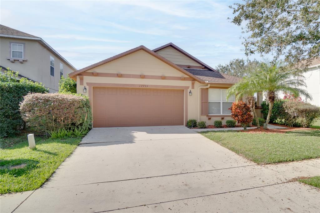 a front view of a house with a yard and garage