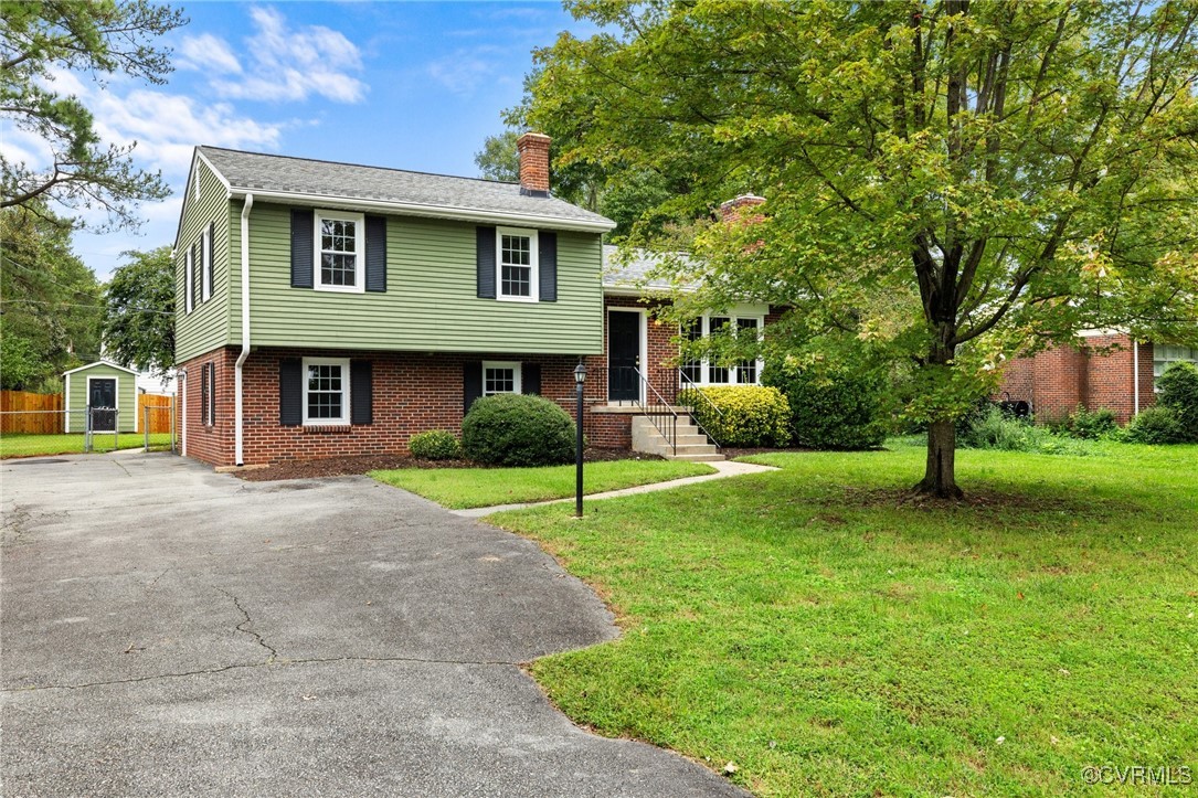 a view of a house with a yard and a patio