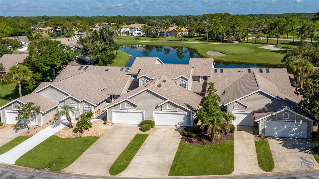 an aerial view of a house with a yard table and chairs