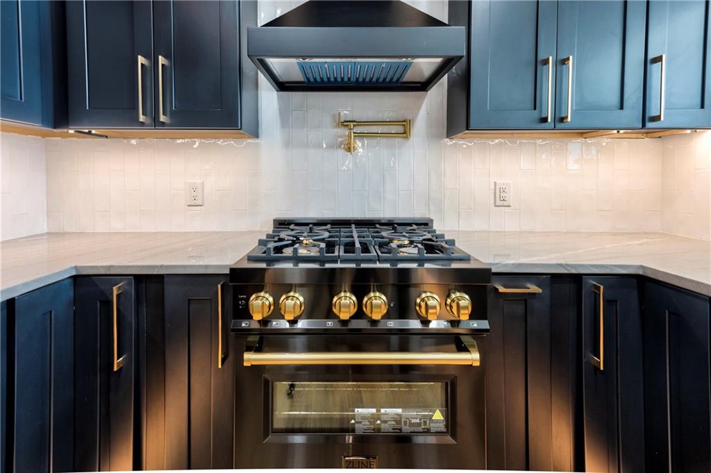 a kitchen with stainless steel appliances granite countertop a stove and a microwave