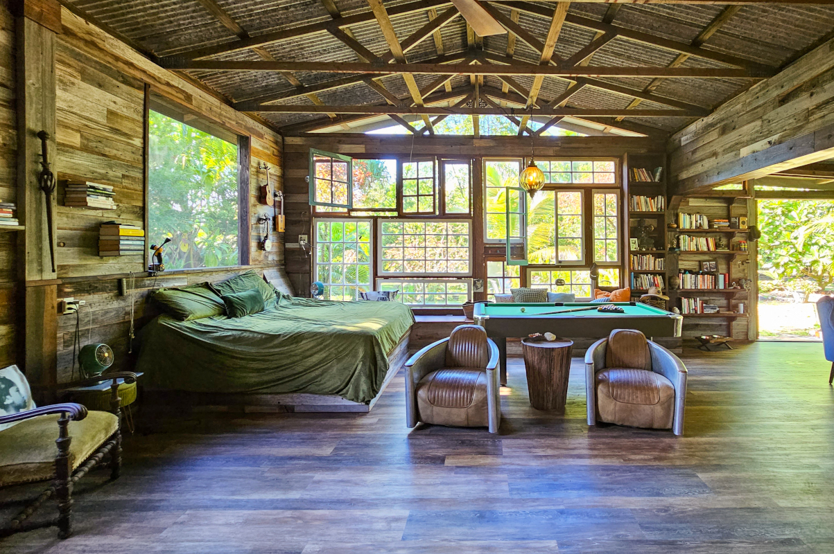 a bedroom with furniture and a large window