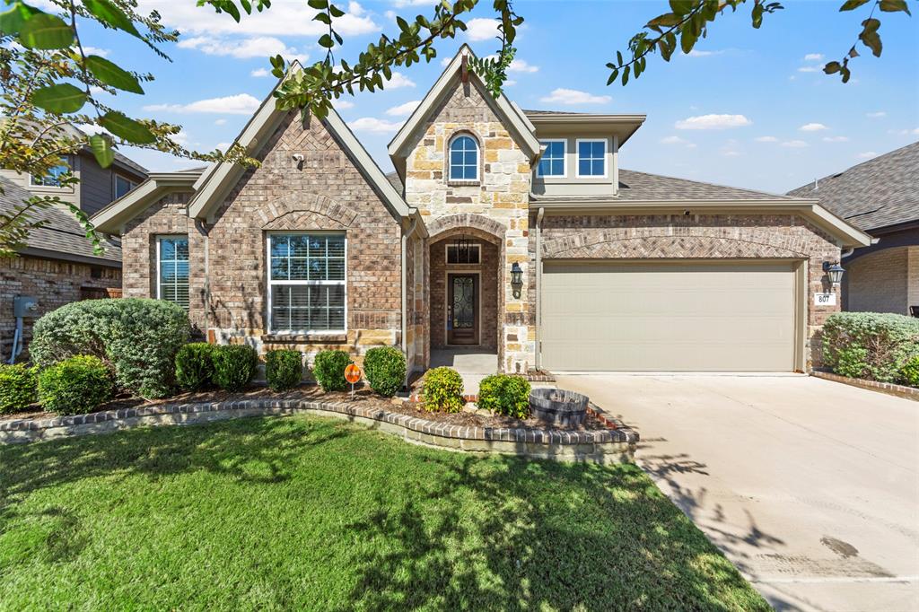 a front view of a house with a yard and garage