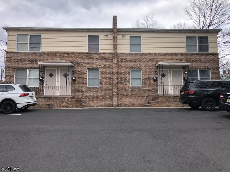 a couple of cars parked in front of a house