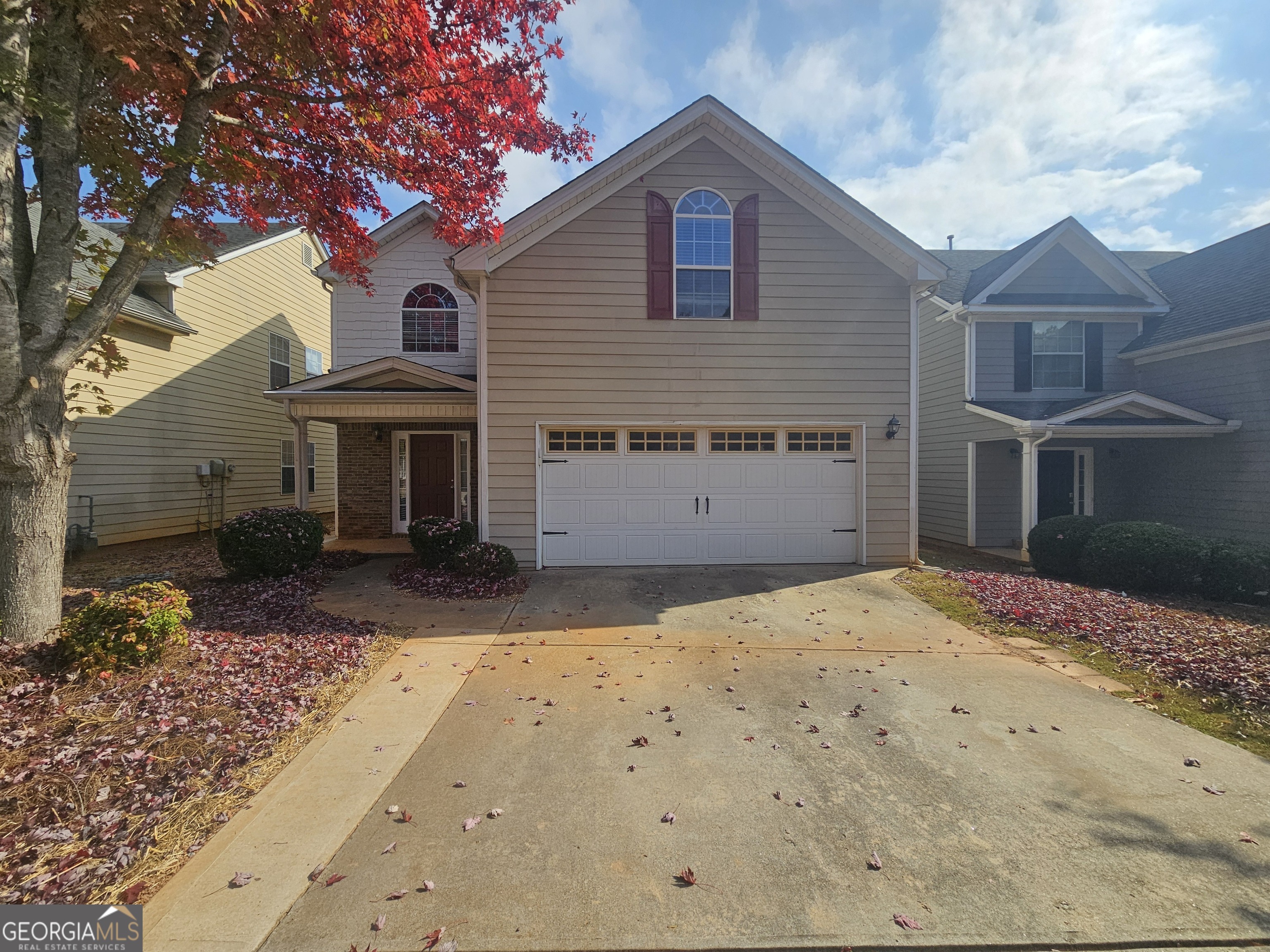 a front view of a house with a yard