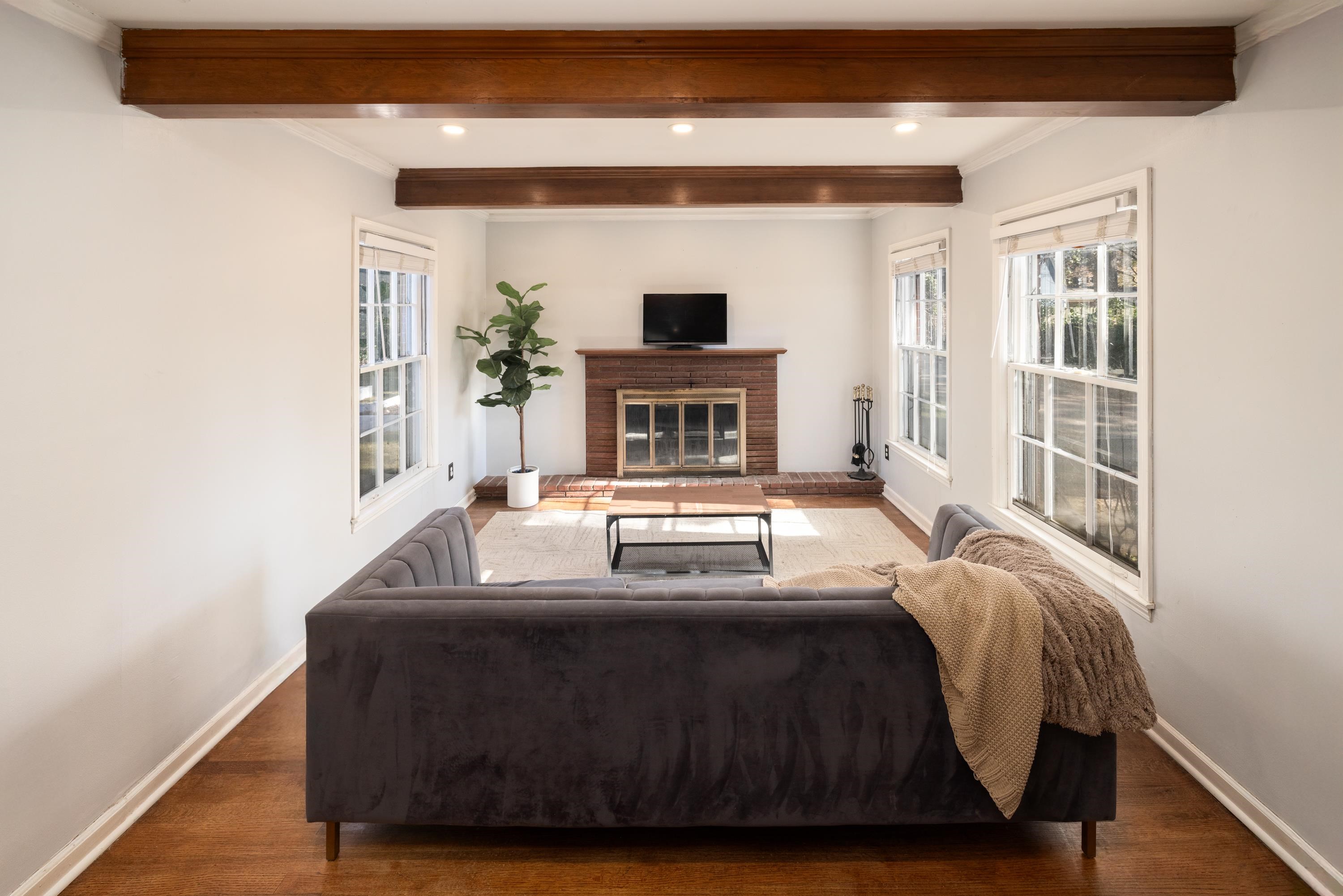 a living room with furniture and a fireplace