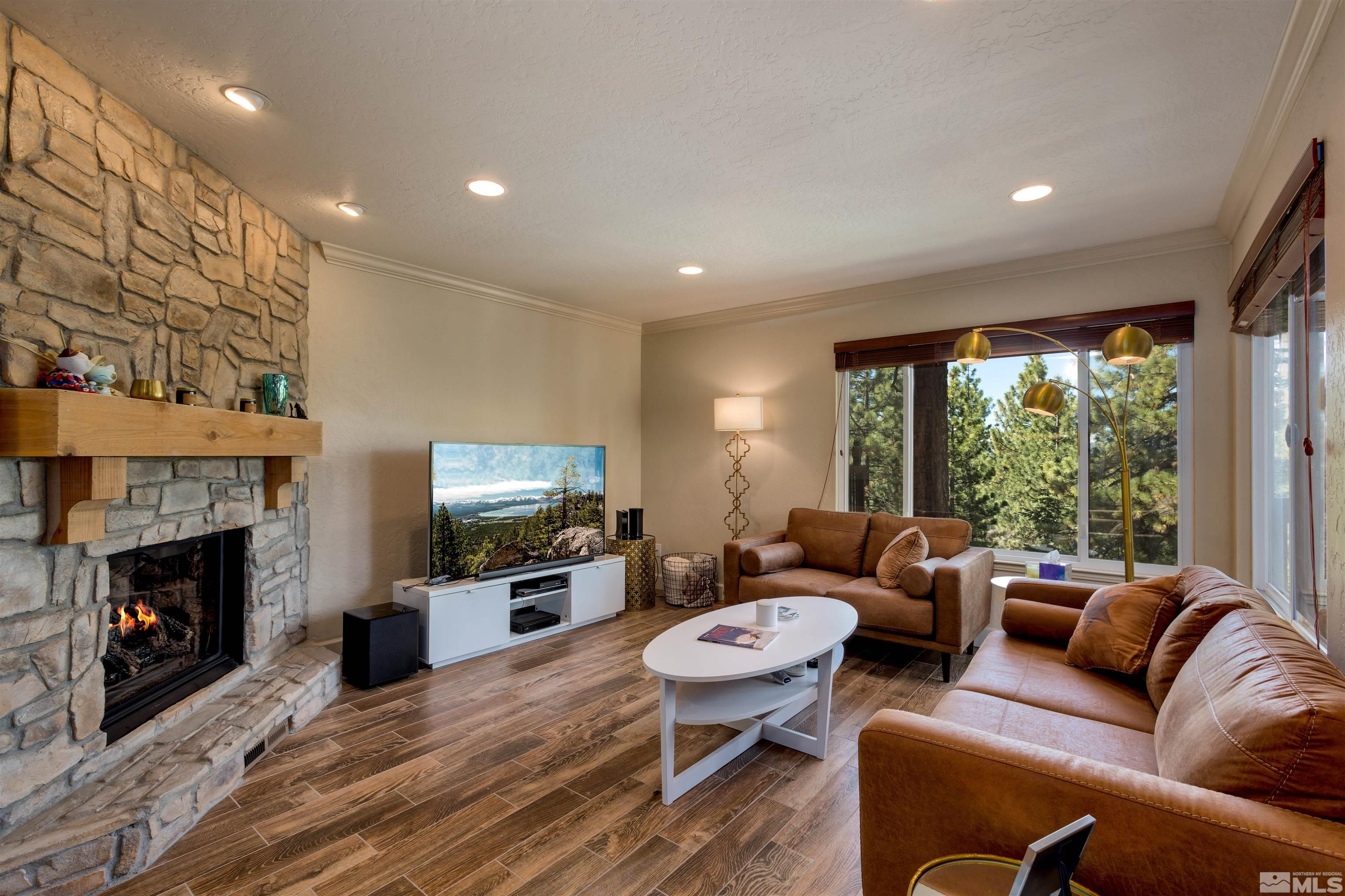 a living room with furniture a fireplace and a flat screen tv