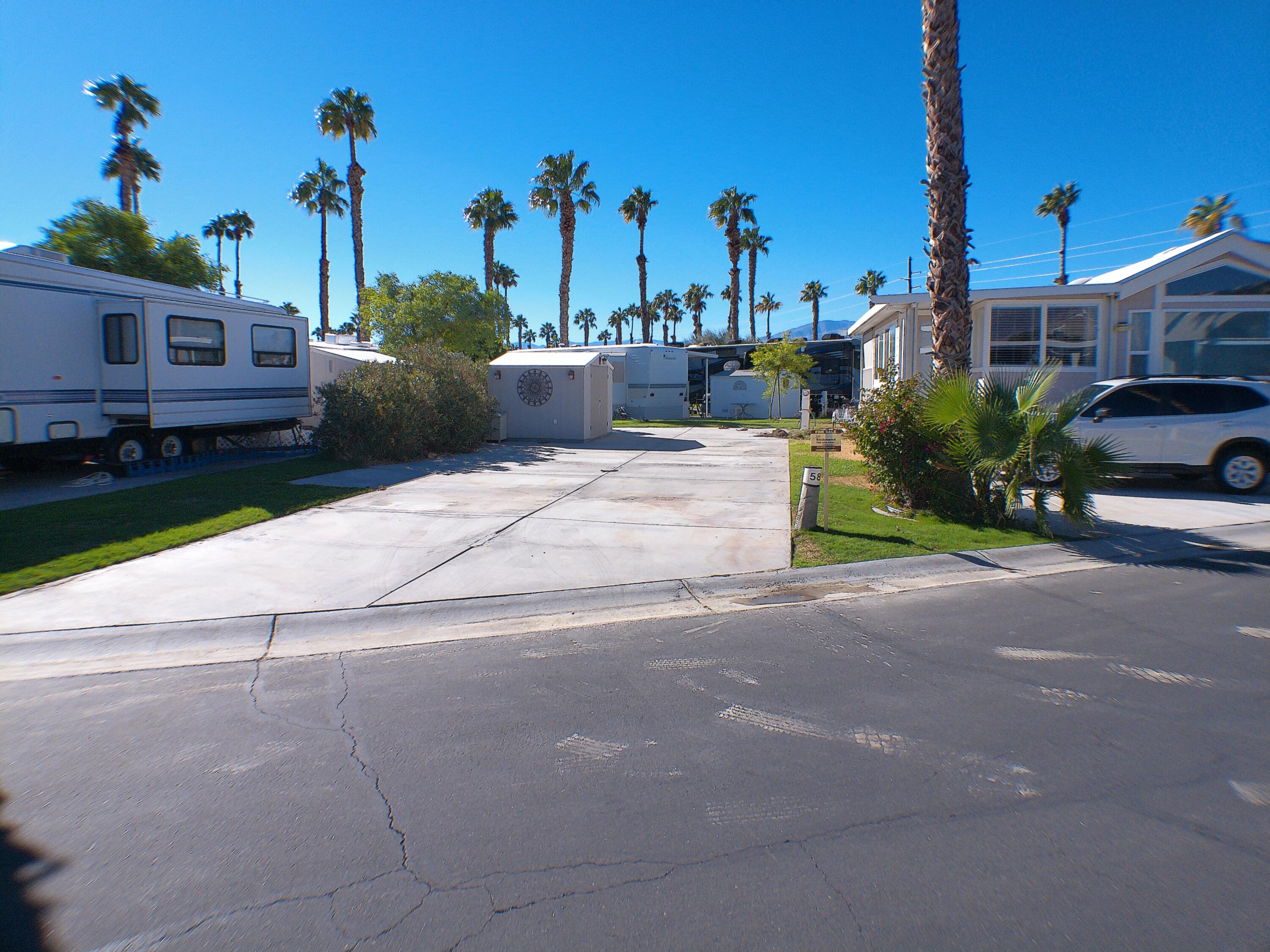 a view of a street with a cars parked