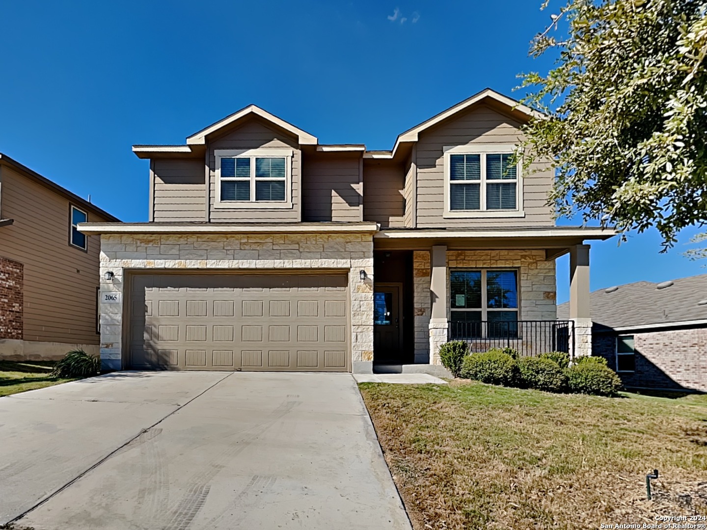 a front view of a house with a yard and garage