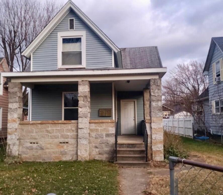 front view of a house with an brick wall