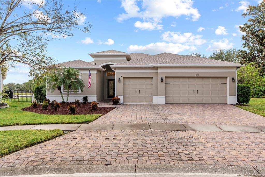 a front view of a house with a yard and garage