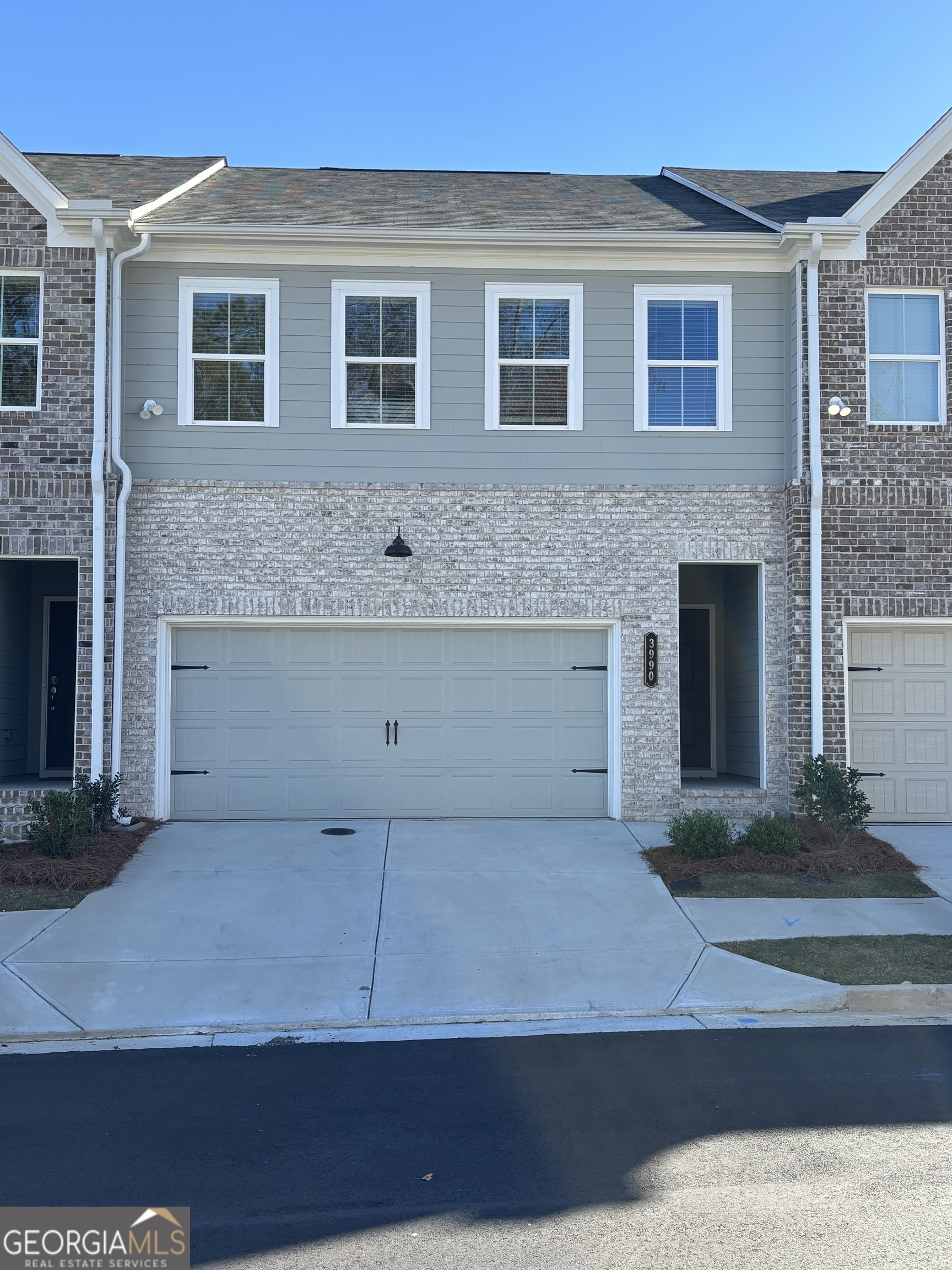 a front view of a house with garage