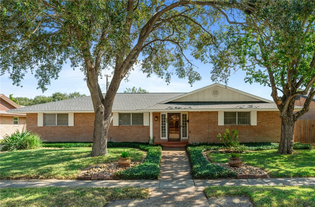 a front view of a house with a garden