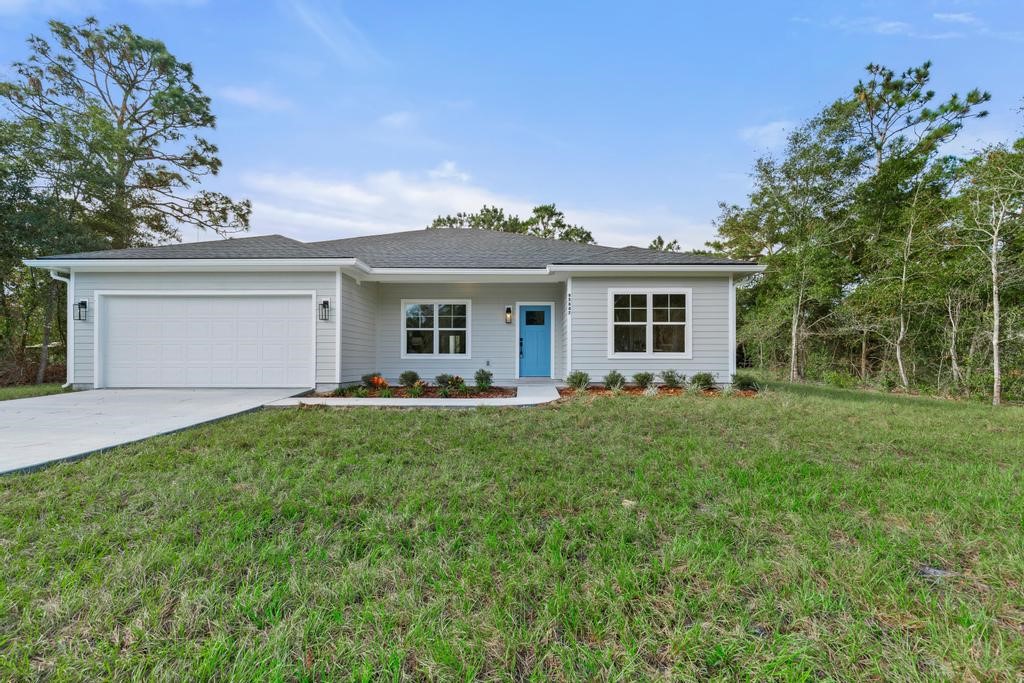 a front view of house with yard and green space