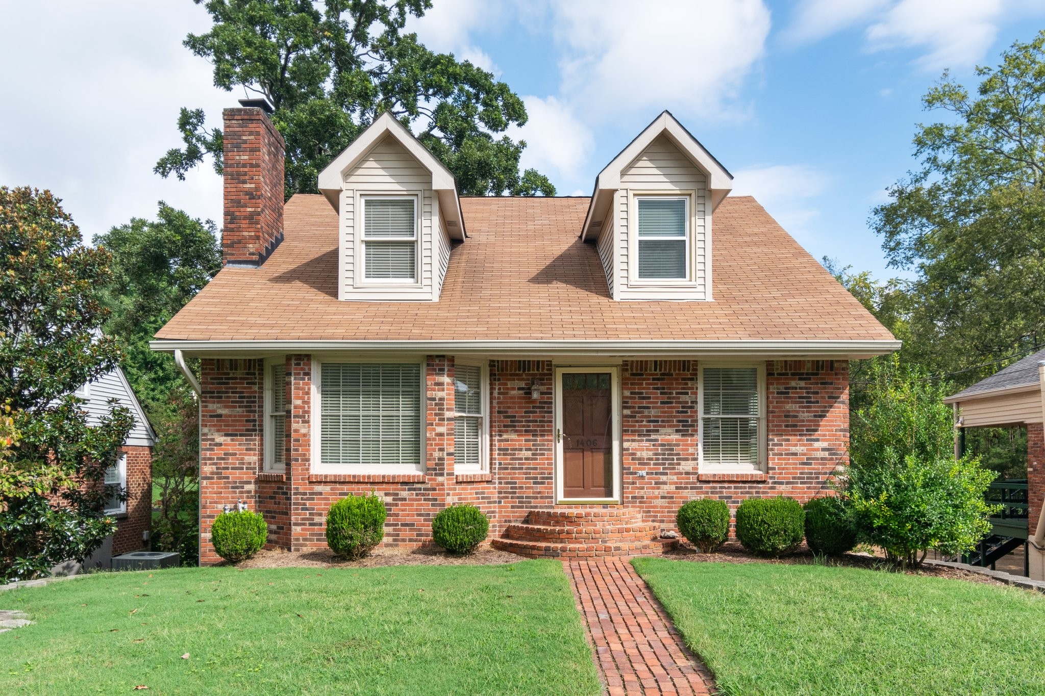 a front view of a house with garden