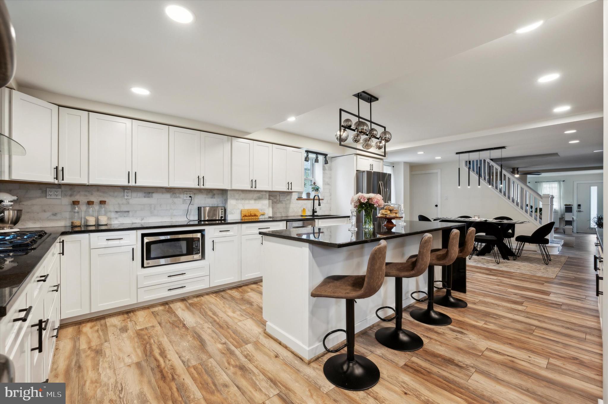 a kitchen with lots of counter top space and stainless steel appliances