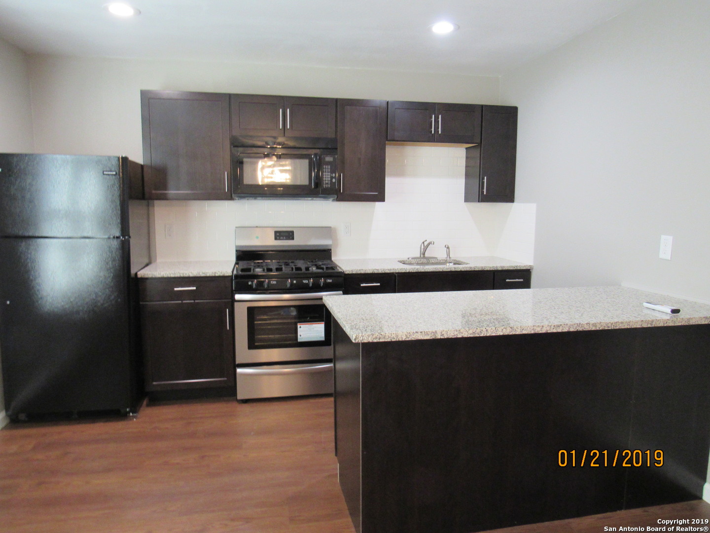 a kitchen with a sink and a refrigerator