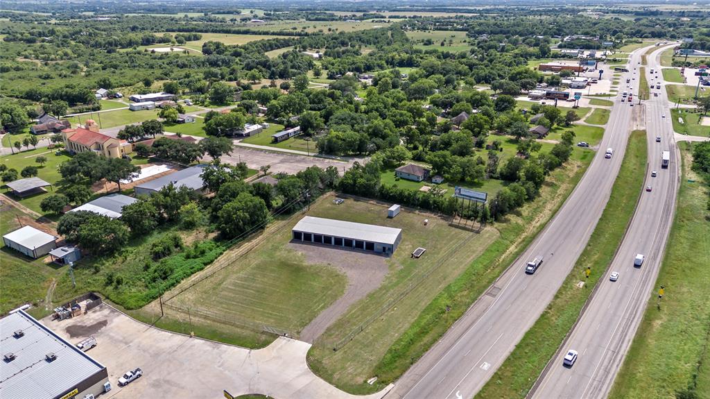 an aerial view of a residential houses with outdoor space and street view