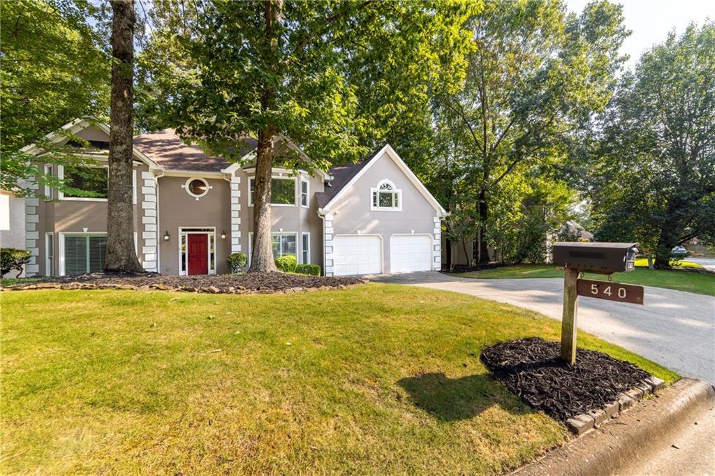 a front view of a house with a yard