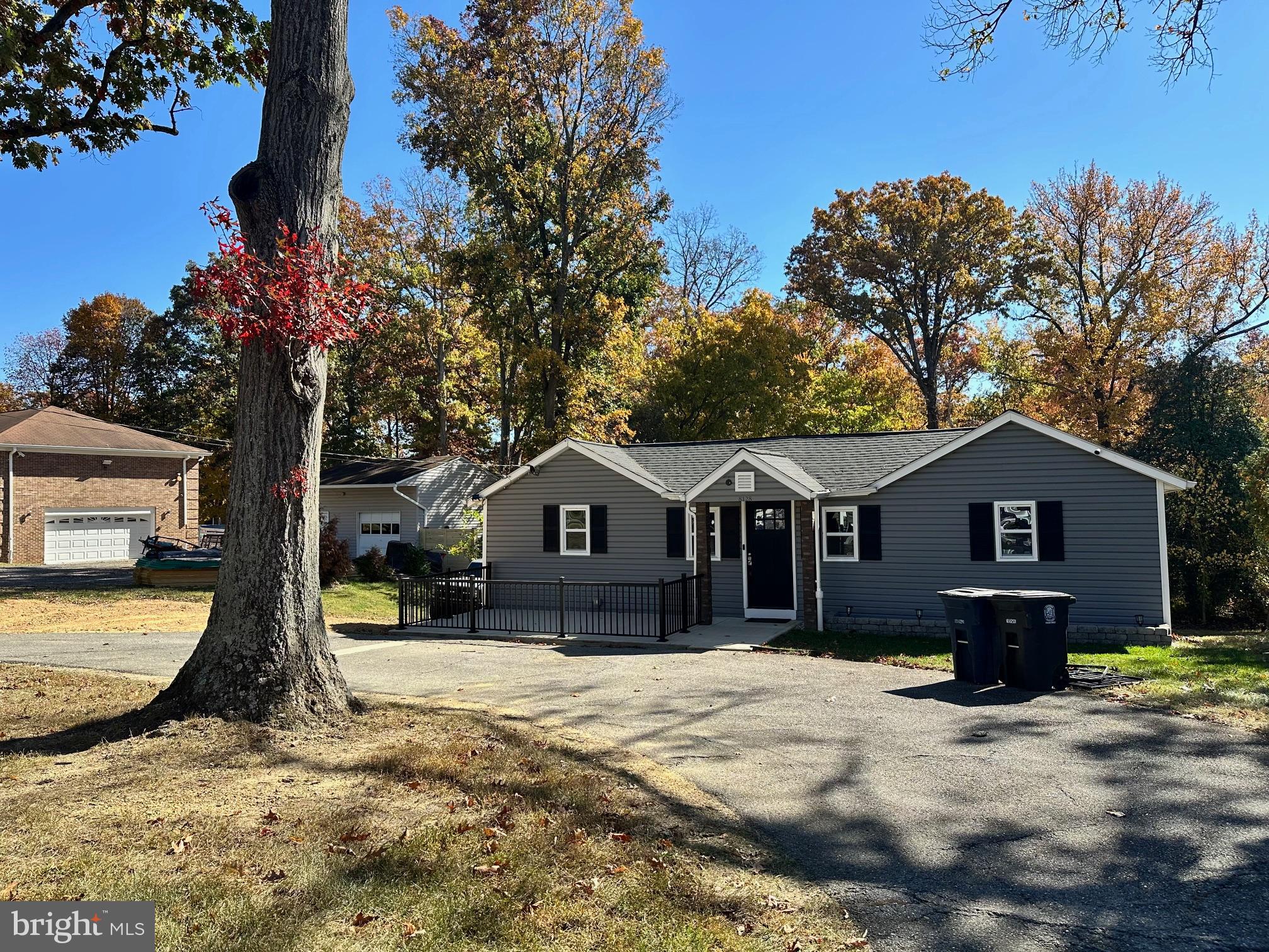 a front view of a house with a yard covered in snow