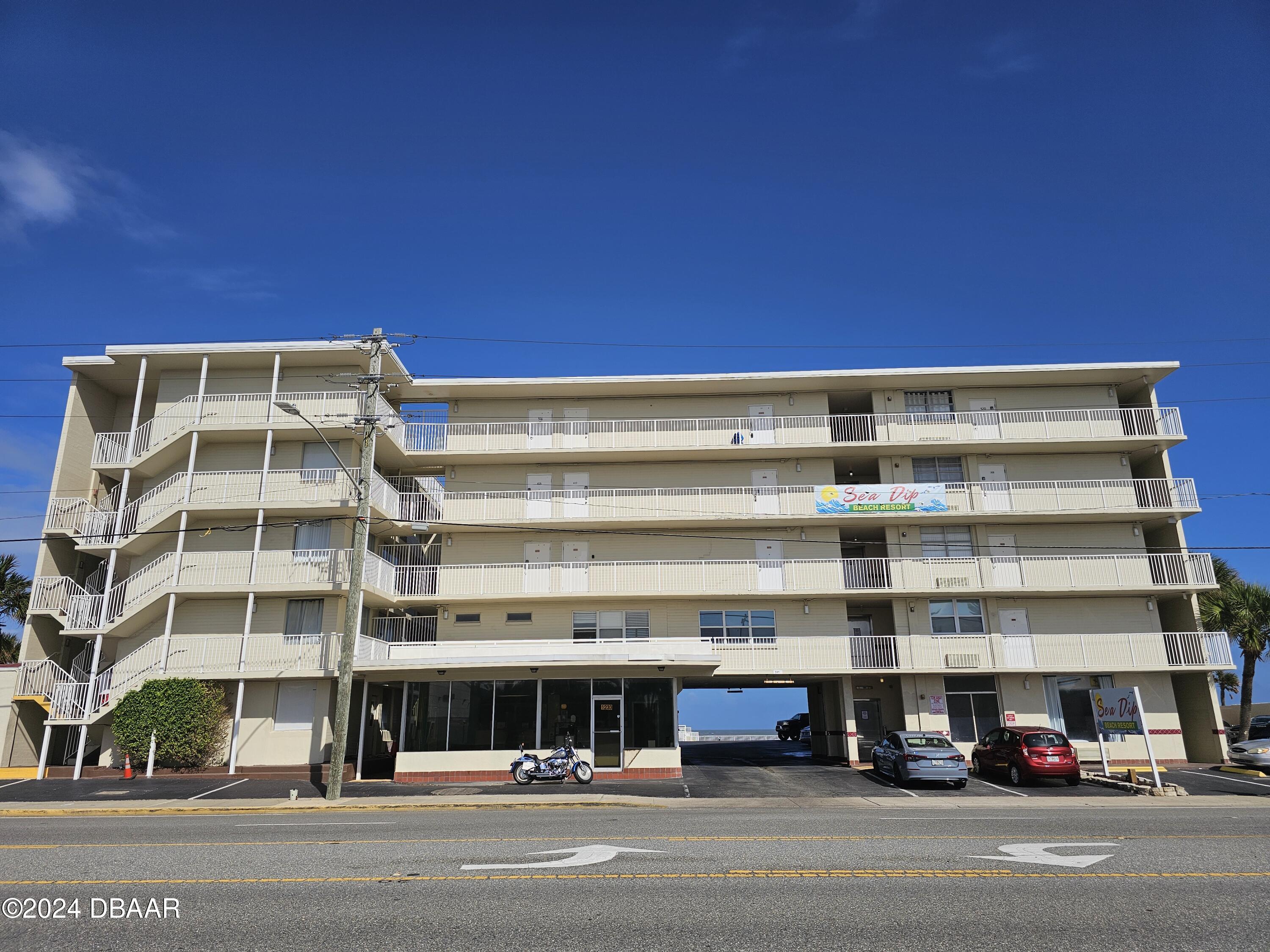 a view of building with car parked