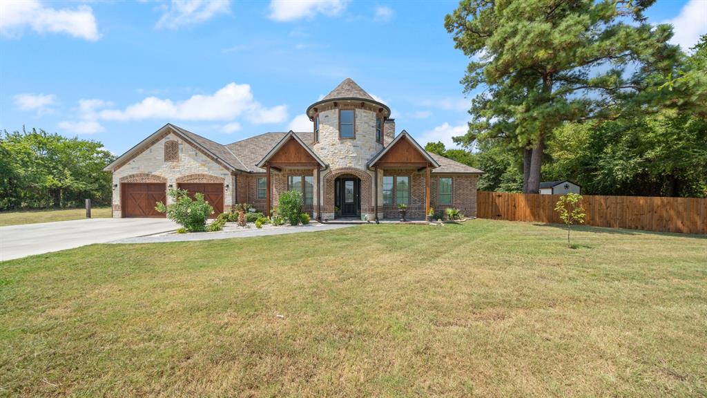 a front view of a house with a garden