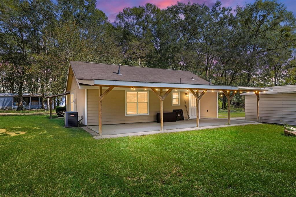 a view of a house with a yard and sitting area