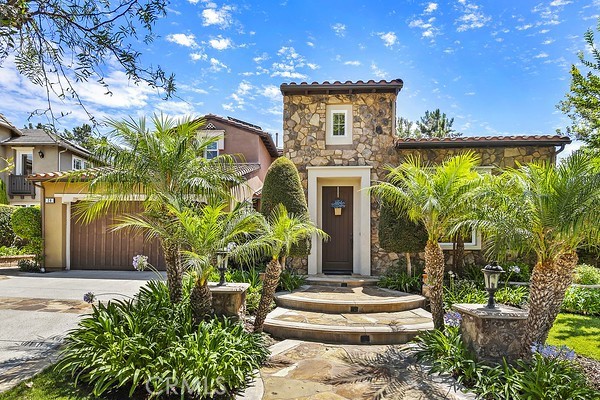 a front view of a house with a yard and fountain