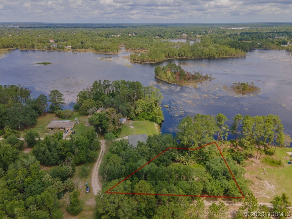 an aerial view of a house and a lake view