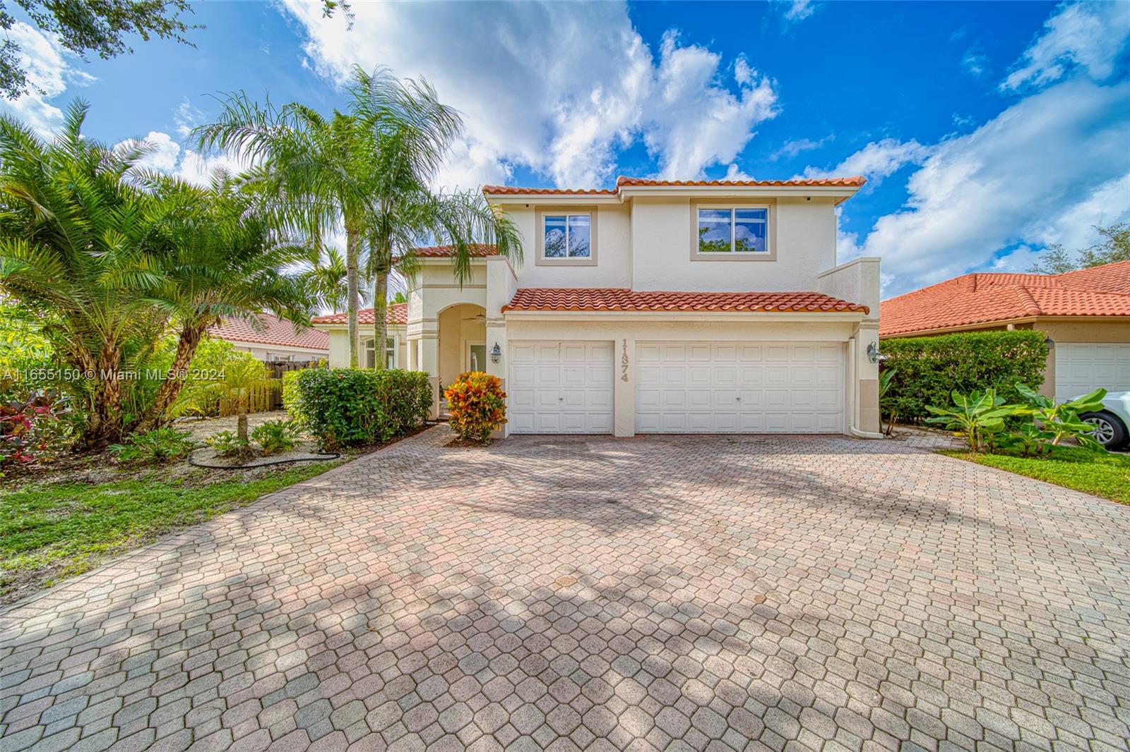 a view of a house with a yard and a garage