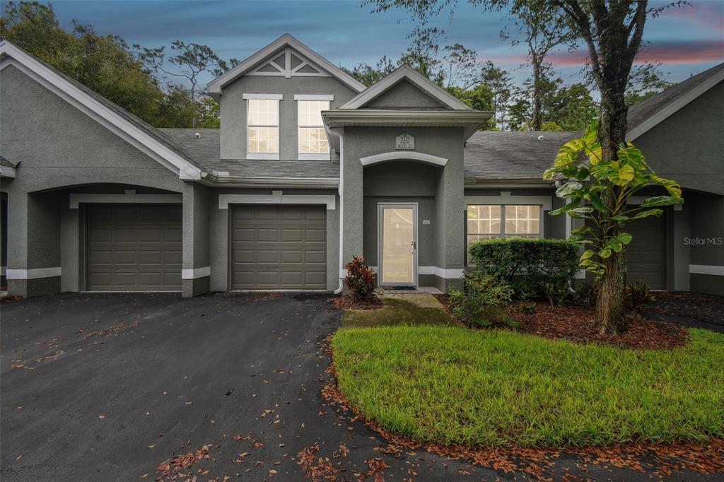 a front view of a house with a yard and garage