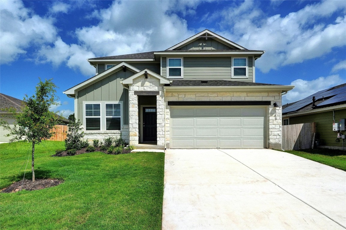 a front view of a house with a yard and garage