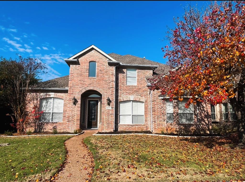 a front view of a house with yard