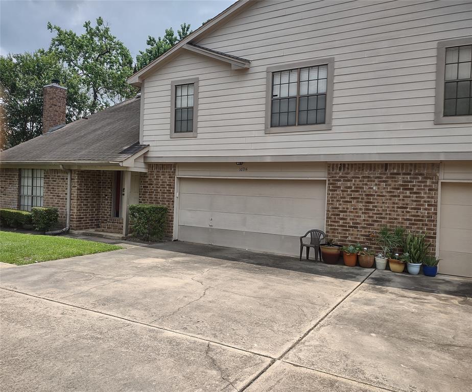 a front view of a house with a yard and a garage