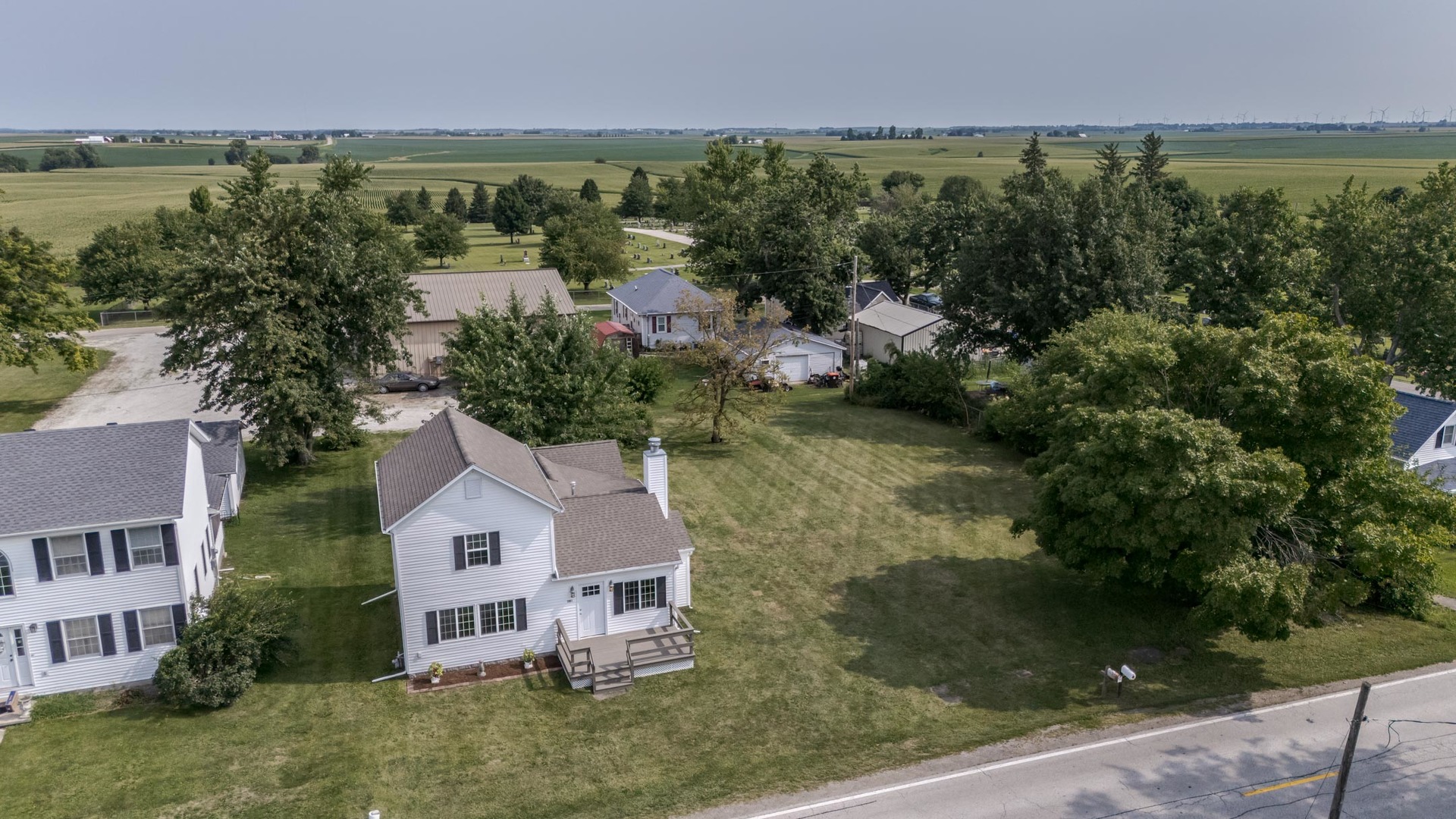 an aerial view of a house with a yard and lake view