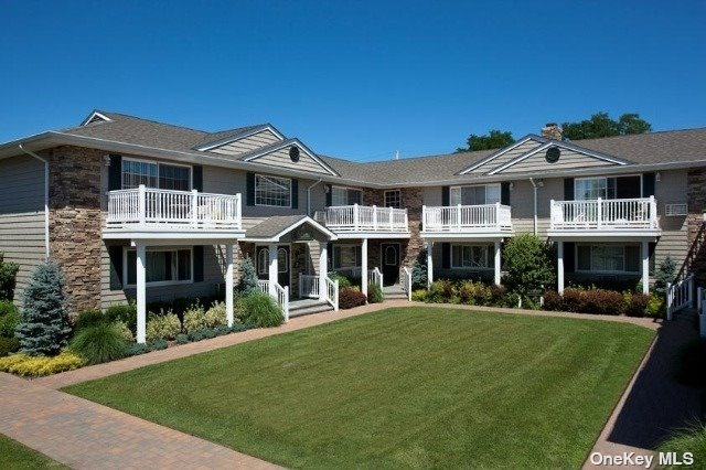 a front view of a house with a yard table and chairs