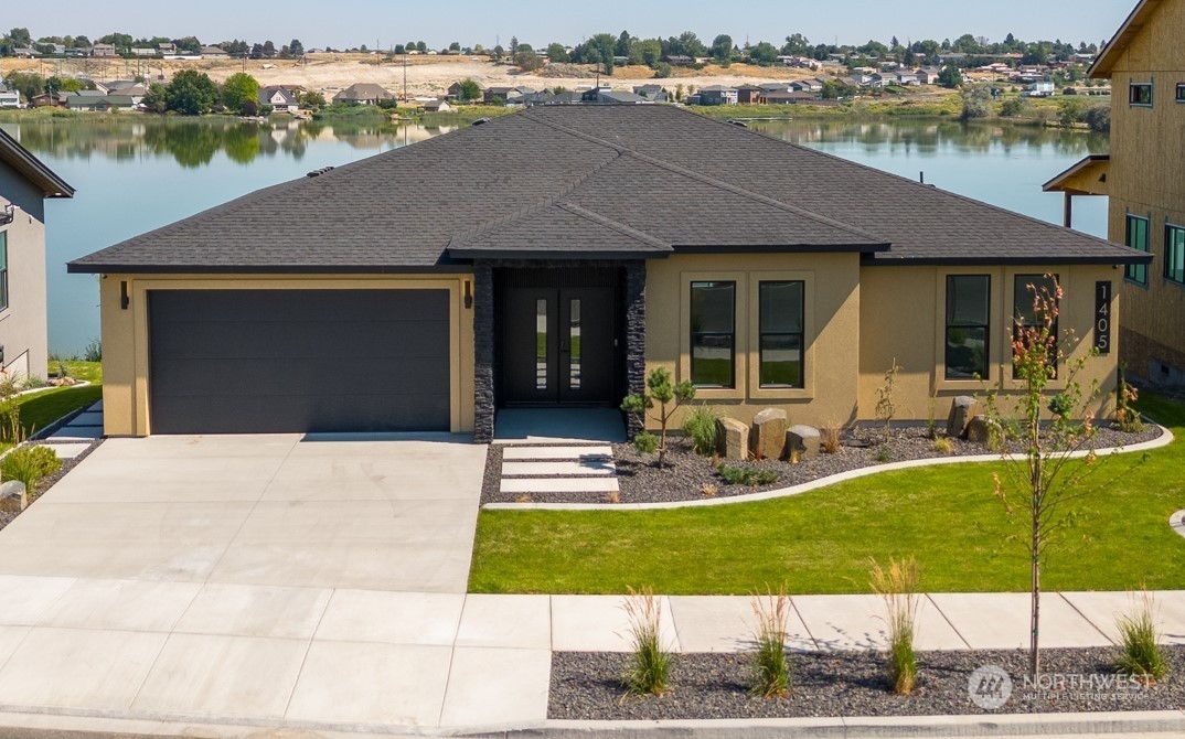 a view of a house with backyard patio and swimming pool