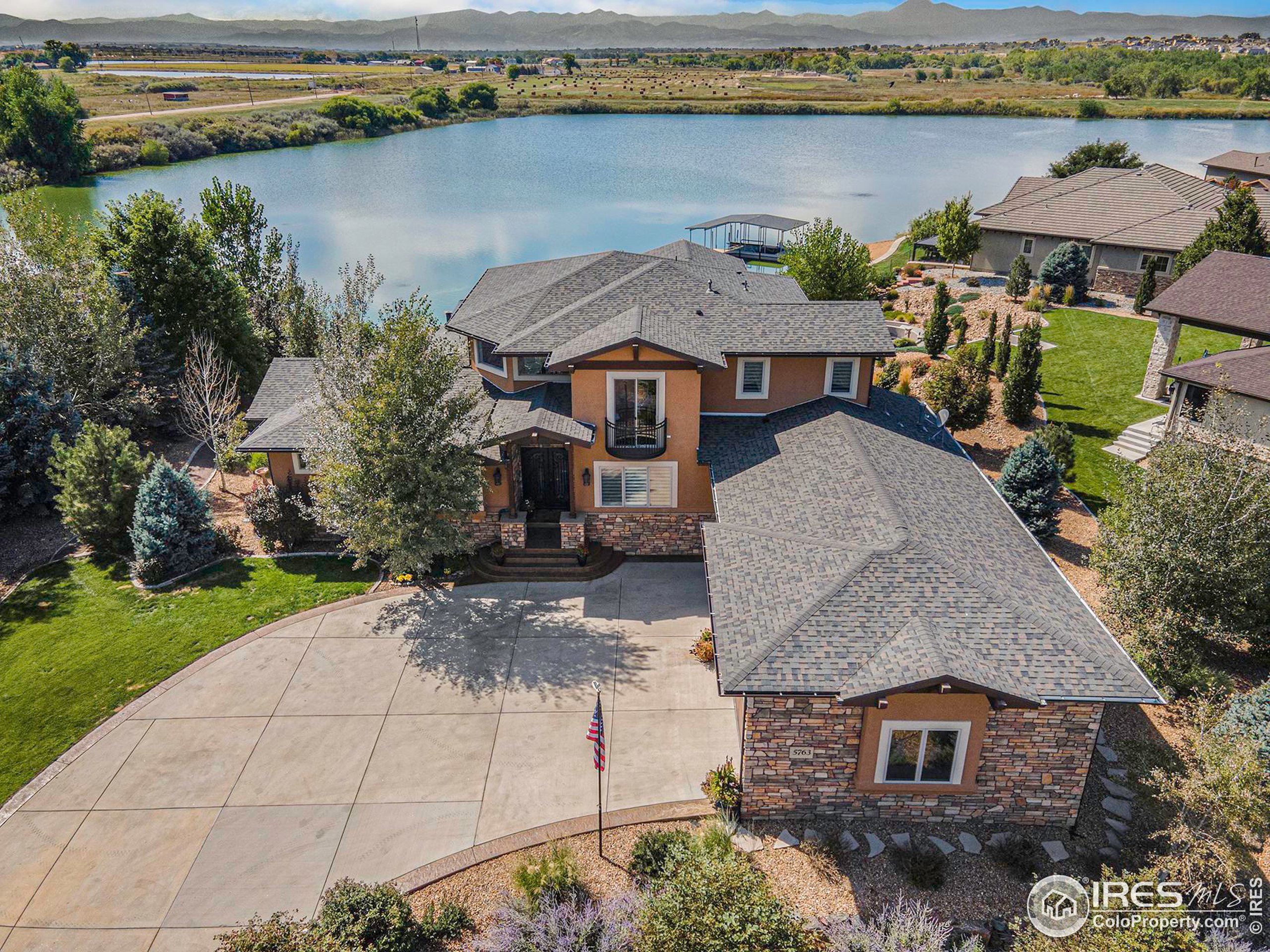 an aerial view of a house with garden space and lake view