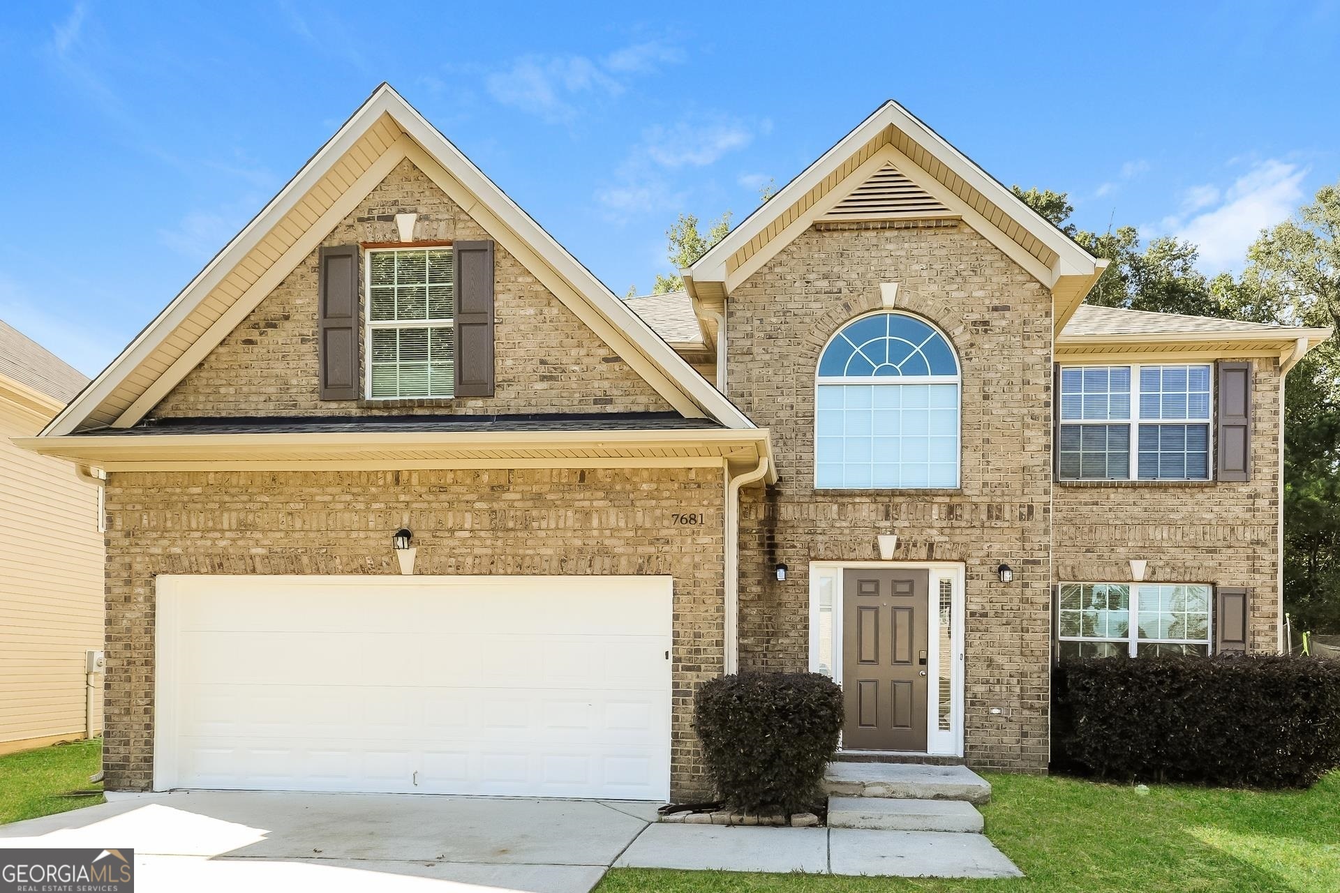 a front view of a house with a yard