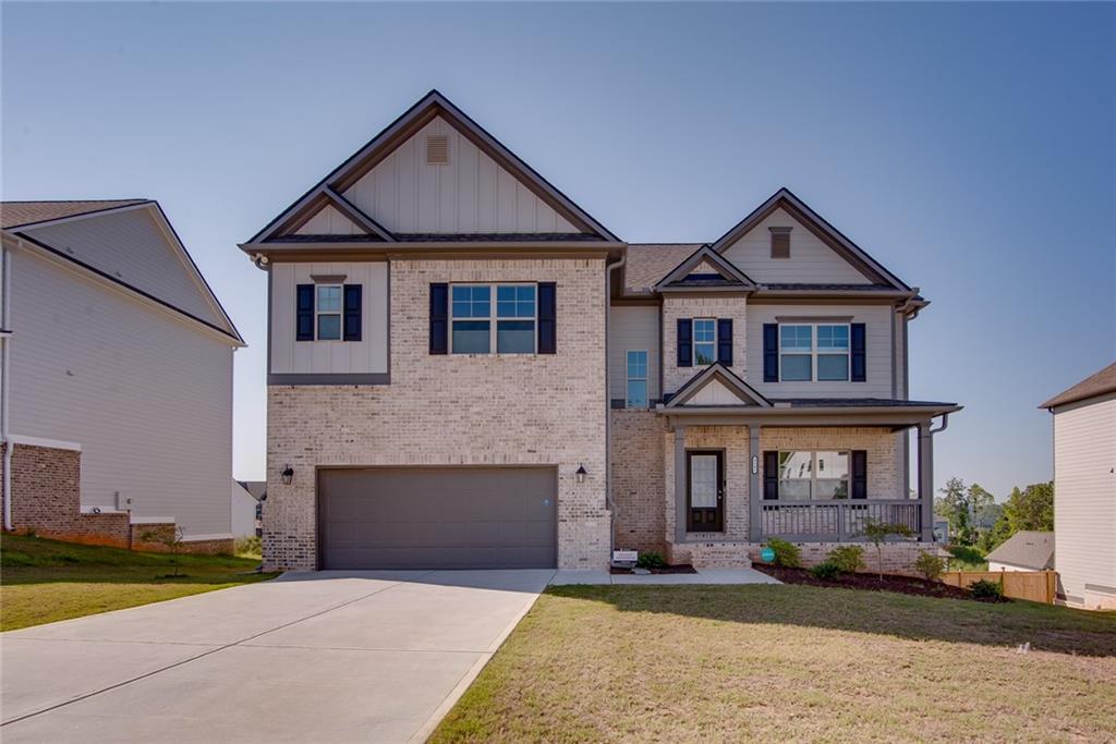 a front view of a house with a yard and garage