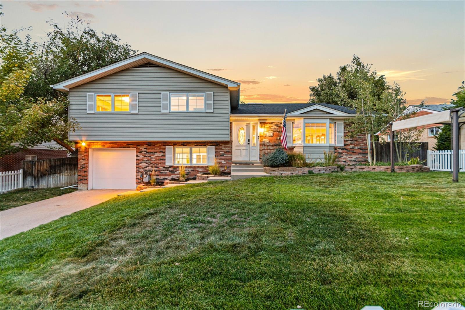 a front view of a house with a yard and garage