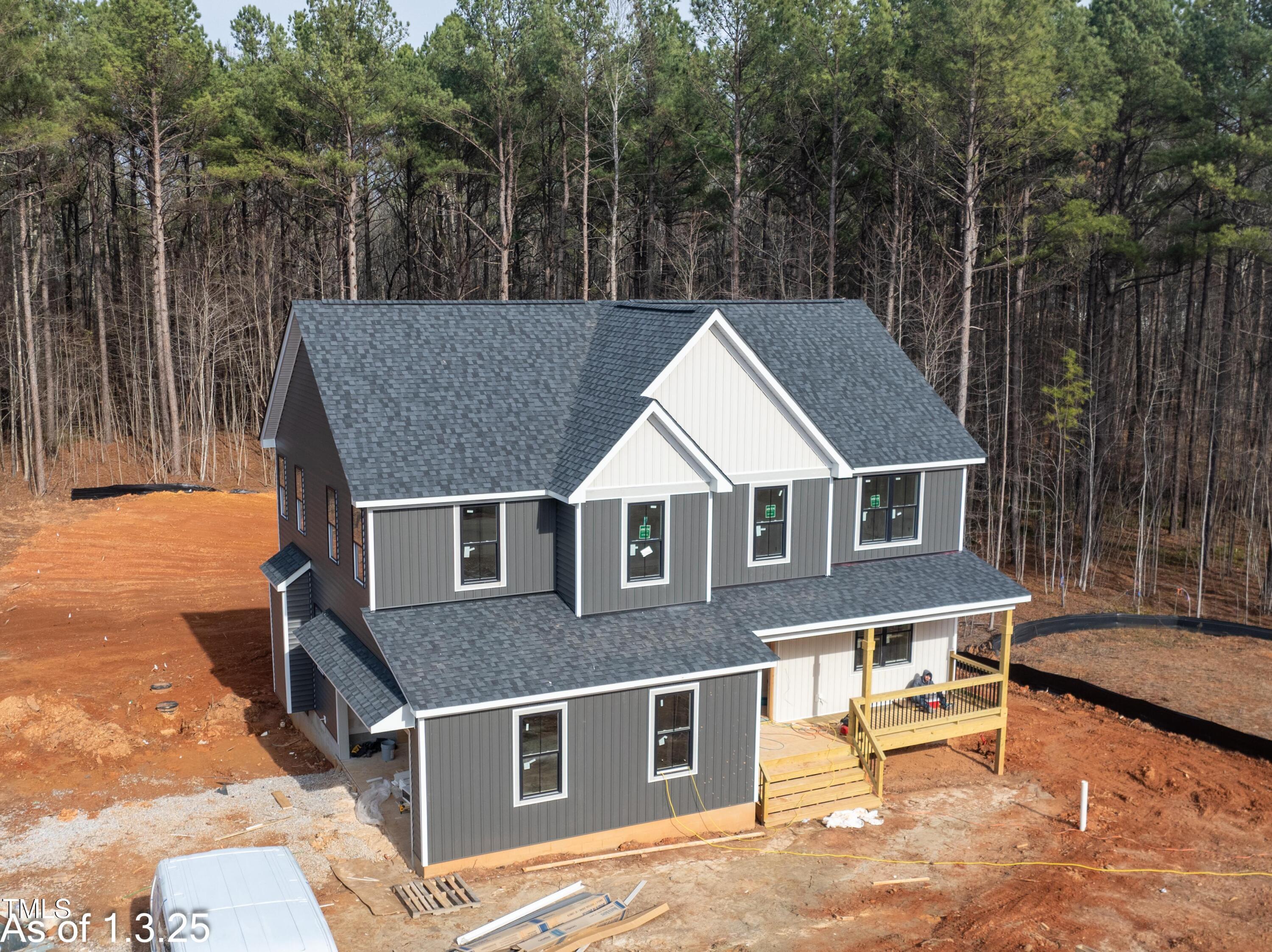 a aerial view of a house with a yard and furniture