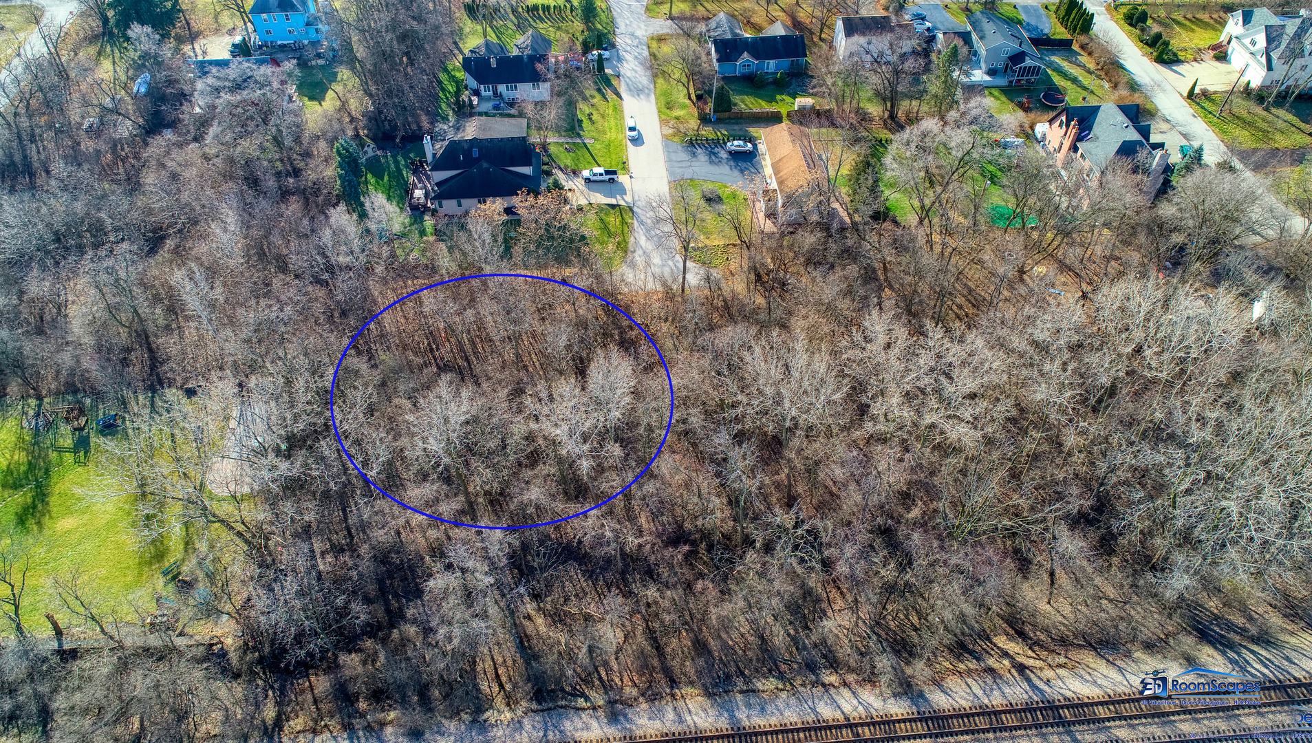 a aerial view of a house with a yard and large trees