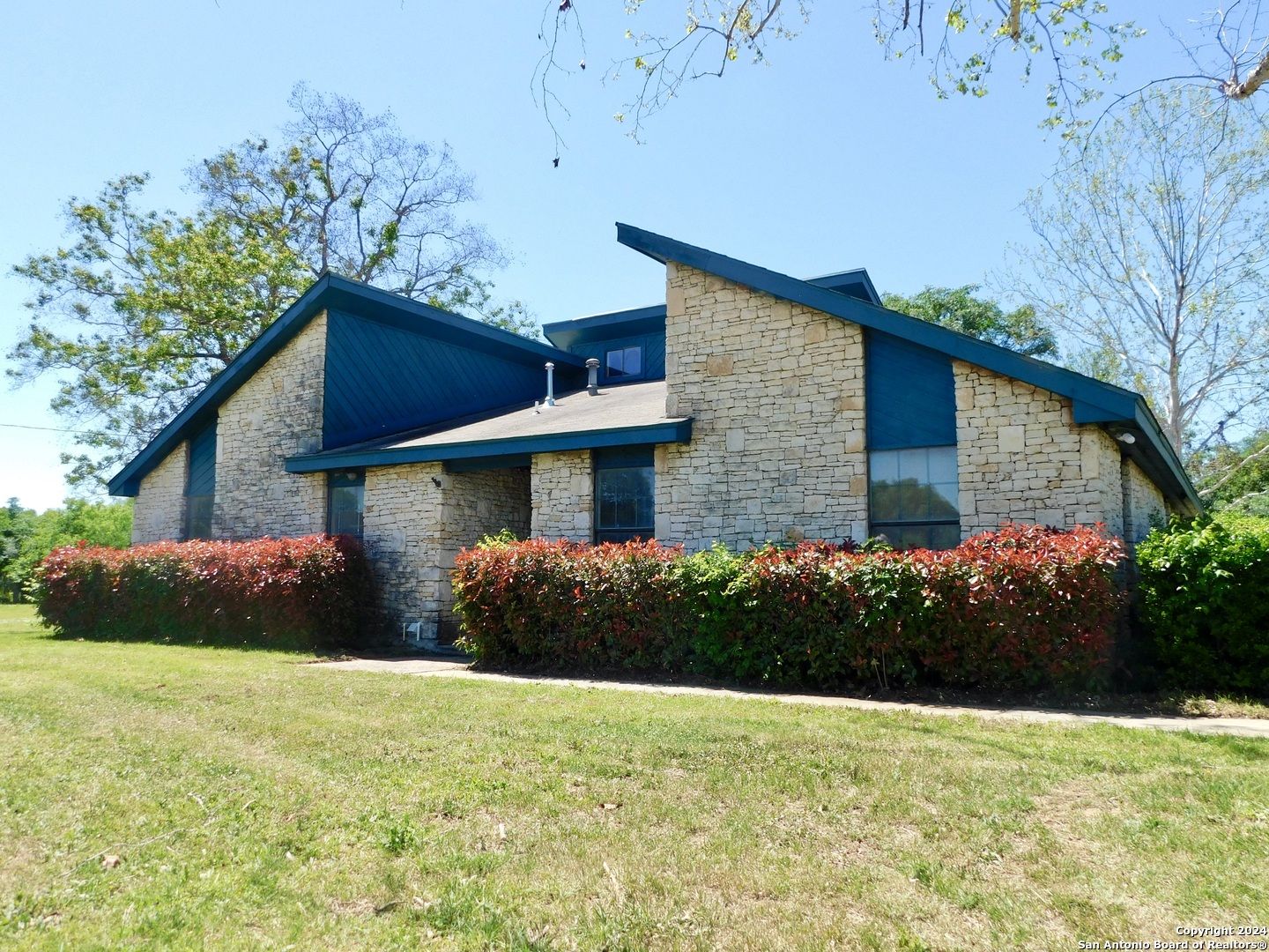 a front view of house with yard and green space