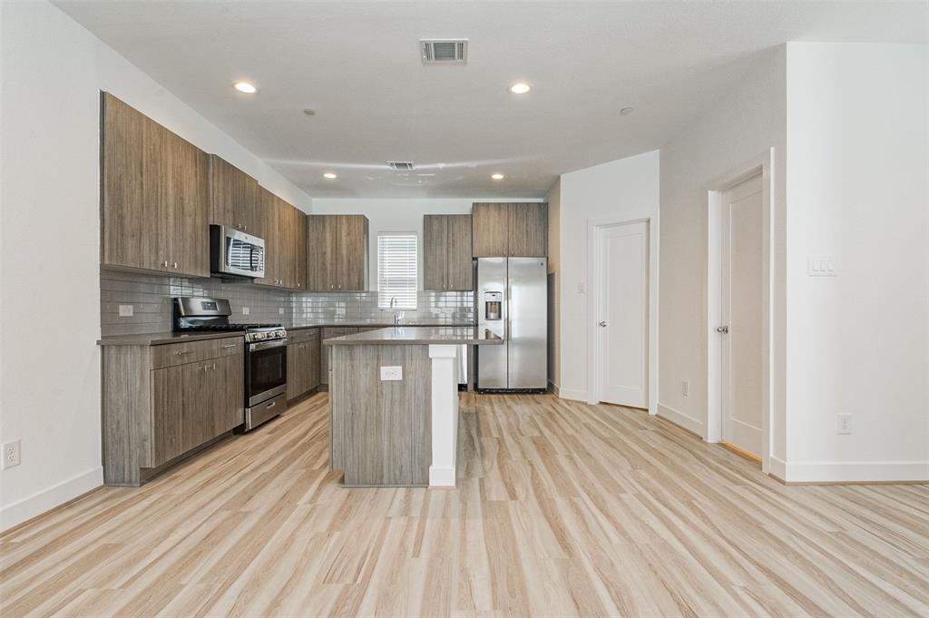 a kitchen with a refrigerator and a microwave