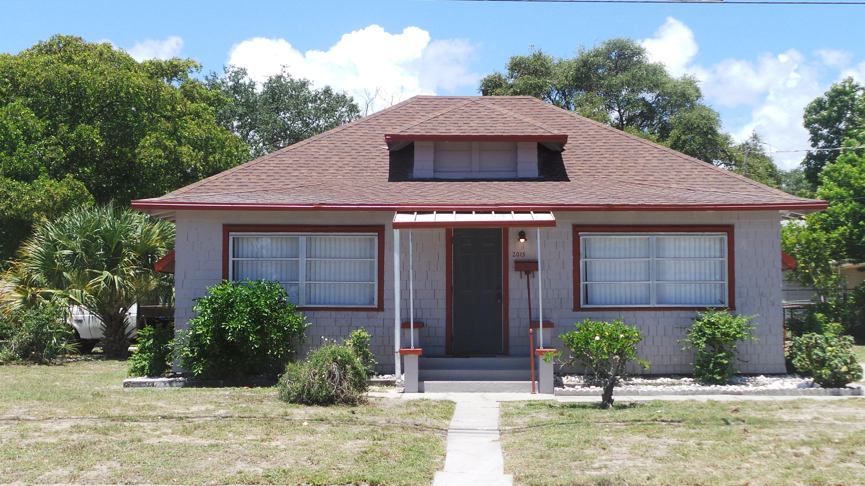 a front view of a house with garden