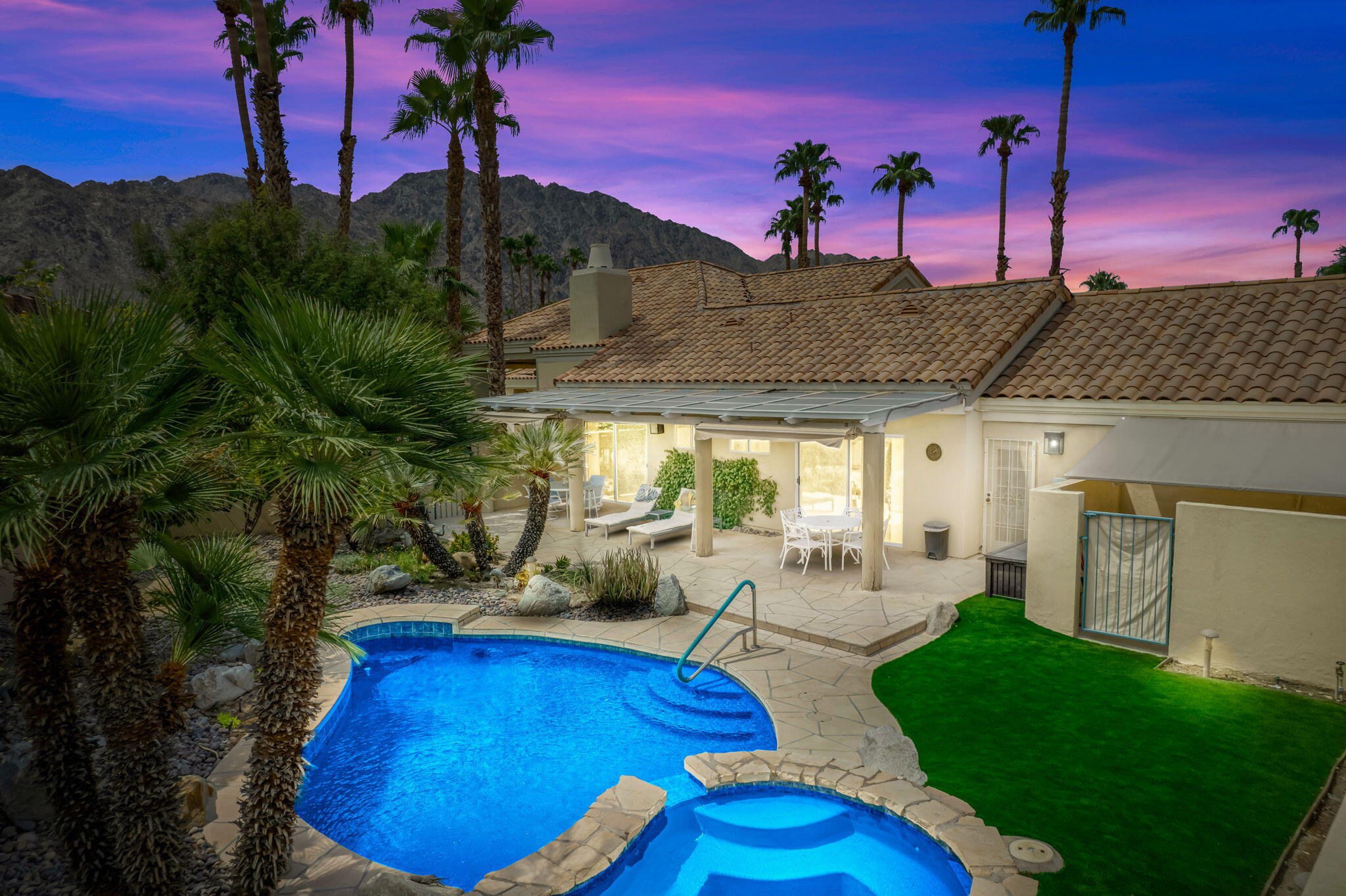 a view of a swimming pool with outdoor seating